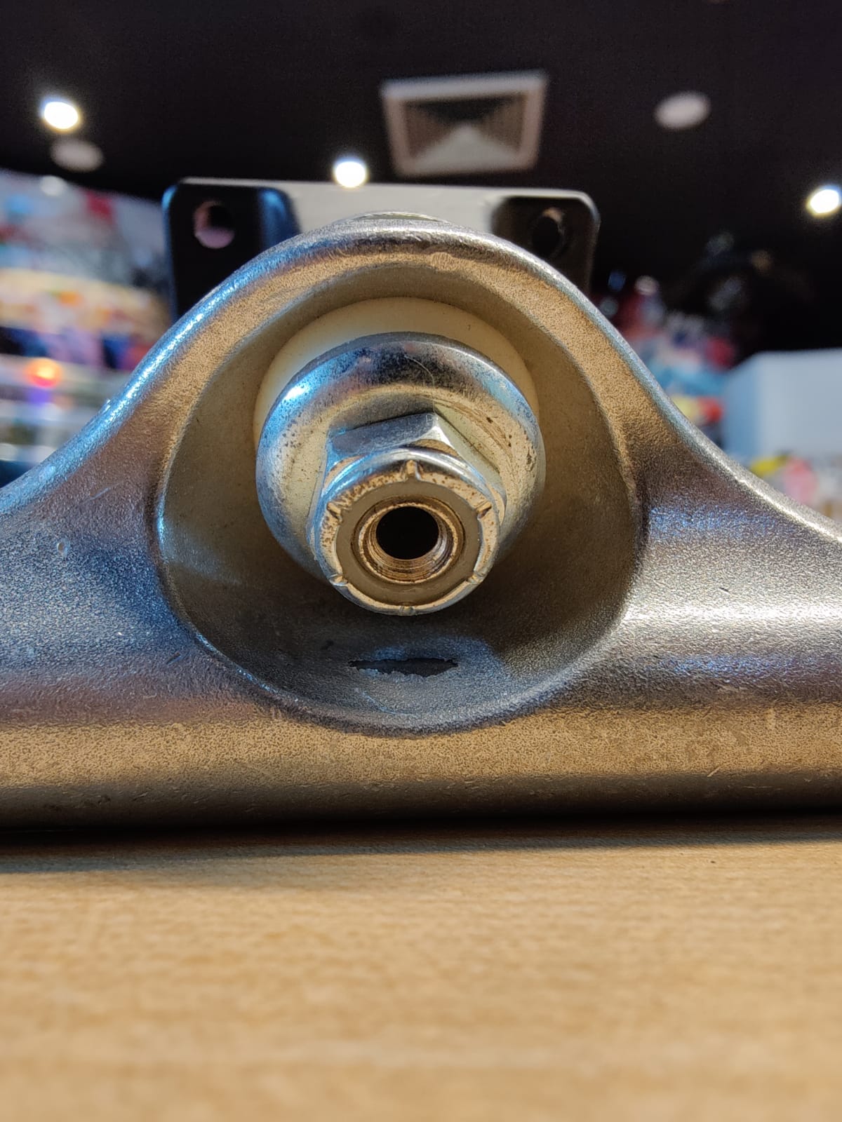 A kingpin is a large bolt nut that controls the amount of pressure put on the bushing. It sticks out of the baseplate.